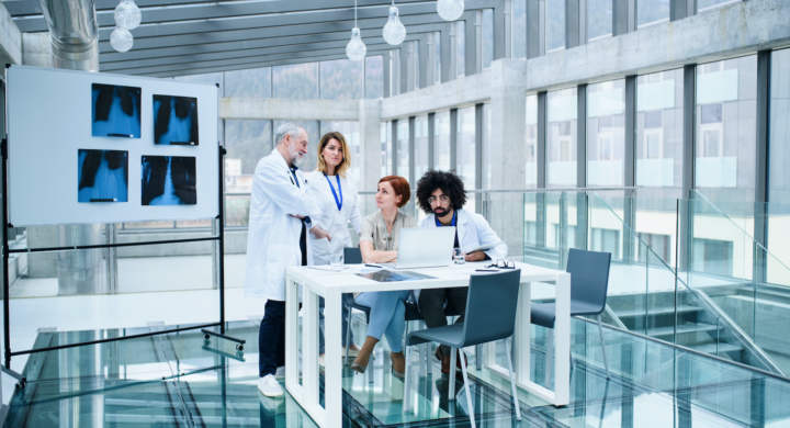 A group of doctors talking about corona virus on conference.