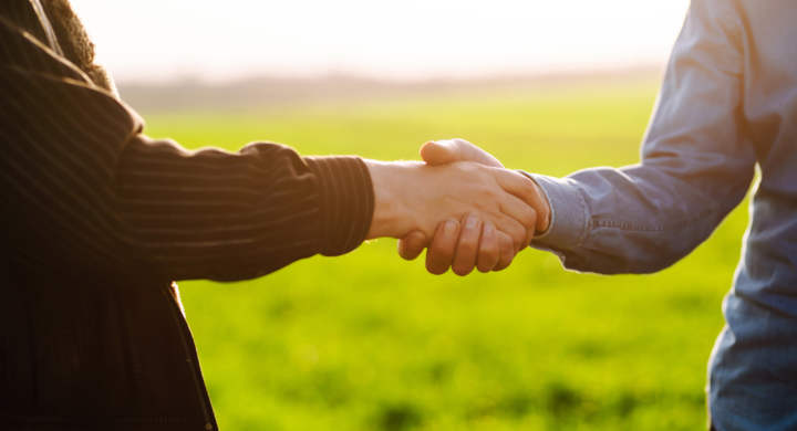 handshake-two-farmer-on-the-background-of-a-wheat-field-at-sunset-the-concept-of-the-agricultural-business