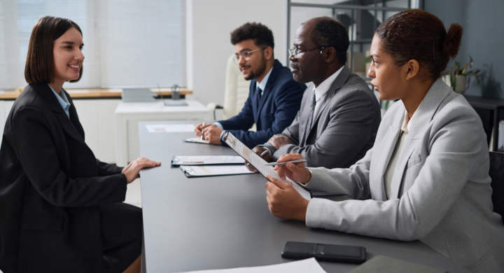 Young woman having an interview with specialists of visa center for getting visa