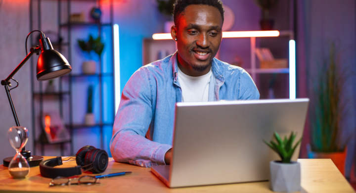 young-man-sitting-at-desk-and-working-on-laptop