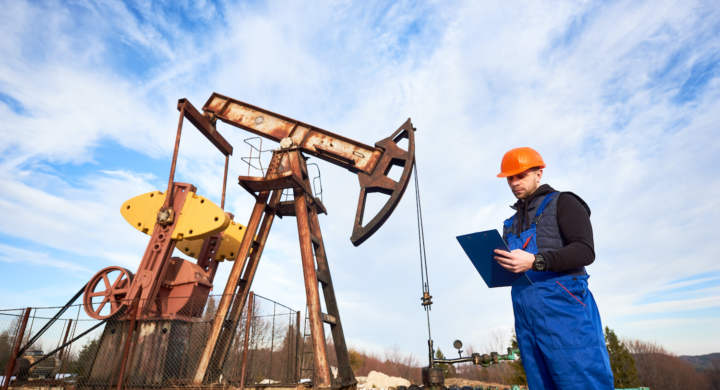 oil-man-checking-work-of-oil-well-pump-jack