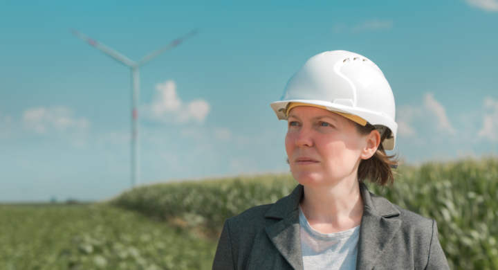 portrait-of-female-engineer-on-modern-wind-turbine-farm