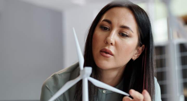 woman-looking-at-model-of-wind-turbine