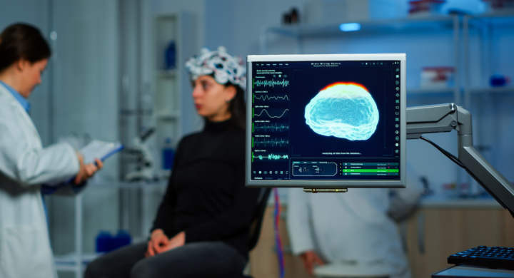 Neurologist doctor analysing nervous system using eeg headset scanning woman brain. Scientist researcher using high tech developing neurological innovation, monitoring side effects on monitor screen
