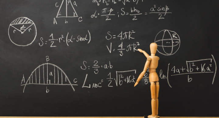 Educational background. Wooden marionette writing mathematics sums with chalk on blackboard. Back to school concept