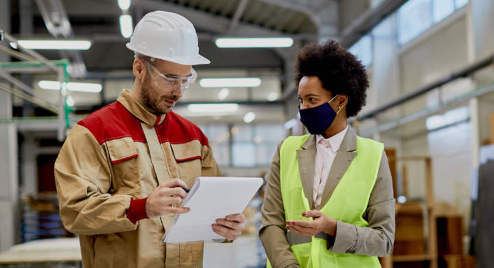 happy-african-american-businesswoman-talking-to-a-worker-at-woodworking-factory