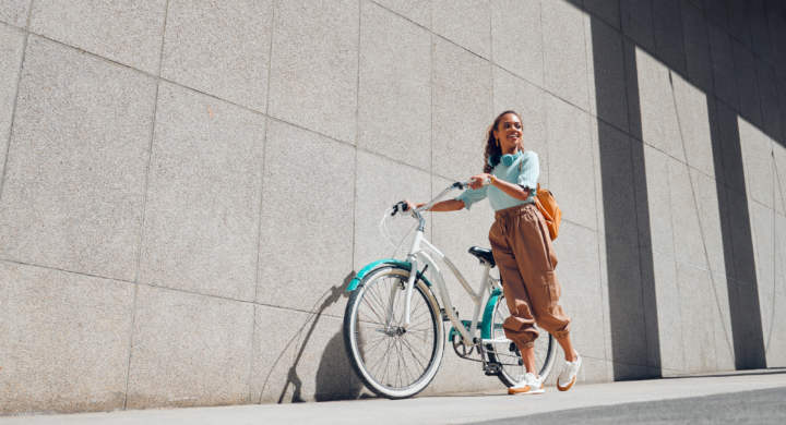 Bike, urban and black woman cycling in the city of Norway for a sustainable lifestyle. Happy, young.