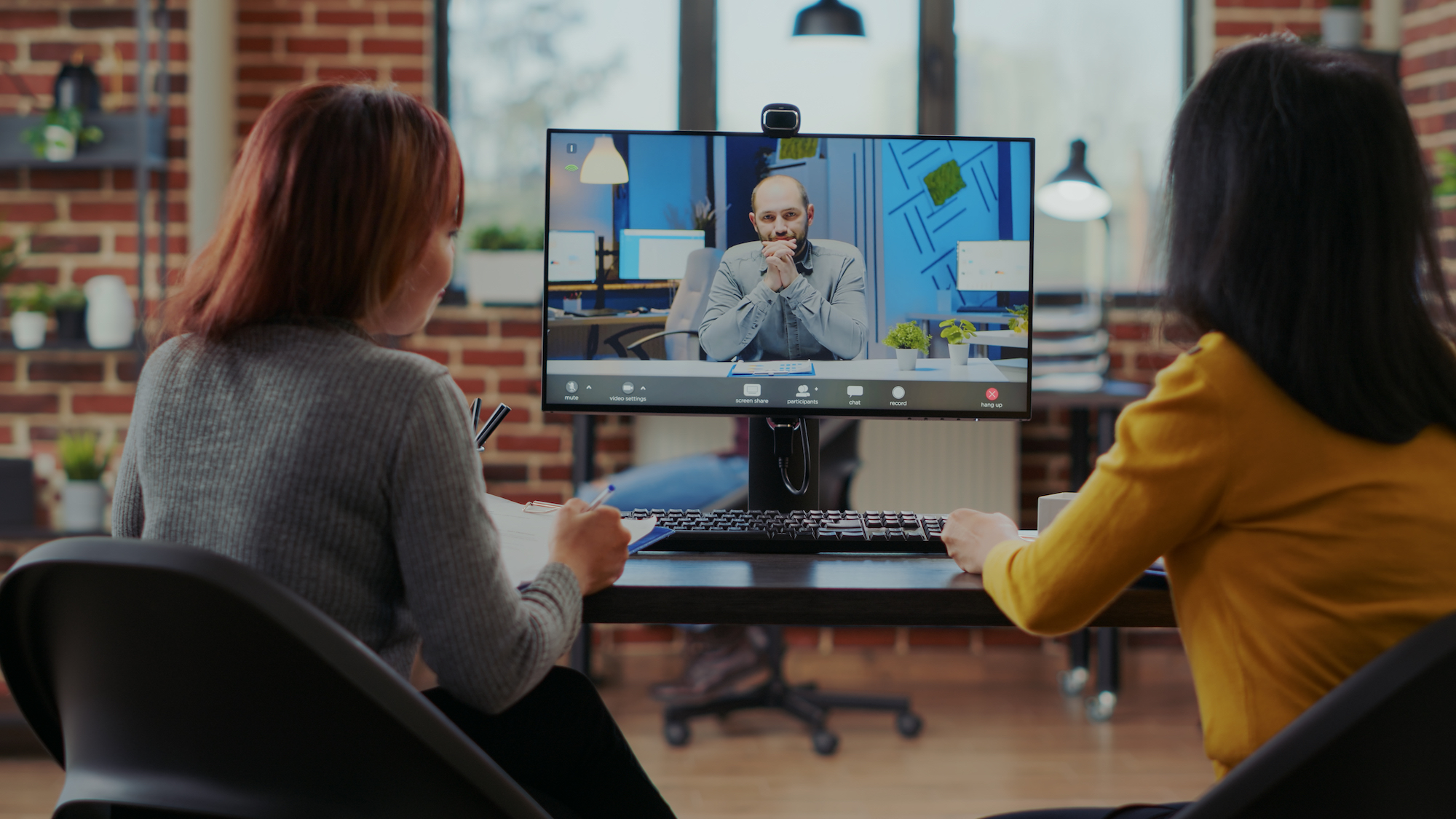 Team of people recruiting candidate on video call job interview in business office to join skilled workforce. Women talking to applicant about work employment and hiring, using remote videoconference on computer.