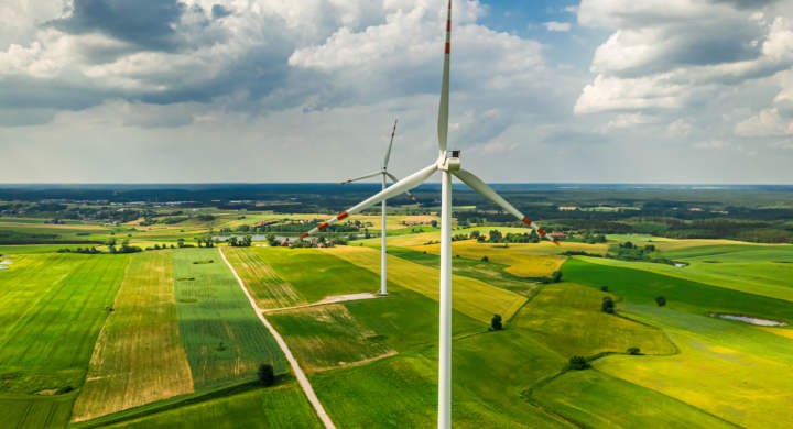 Wind turbines in summer as part of a sustainable food system. Agriculture in countryside in Poland.
