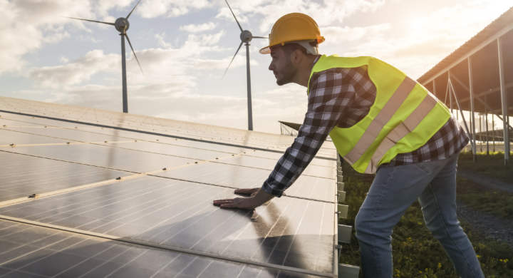 man-working-for-solar-panels-and-wind-turbines-renewable-energy-concept-focus-on-male-worker-hands