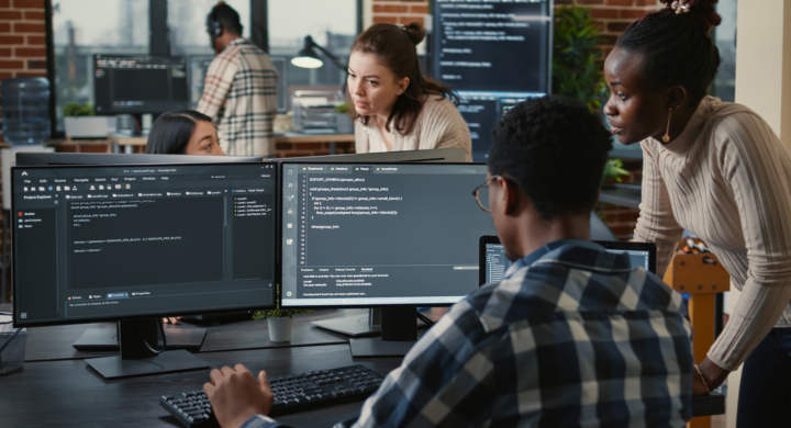 mixed-team-of-artificial-intelligence-cloud-programers-talking-about-programming-in-front-of-multiple-screens