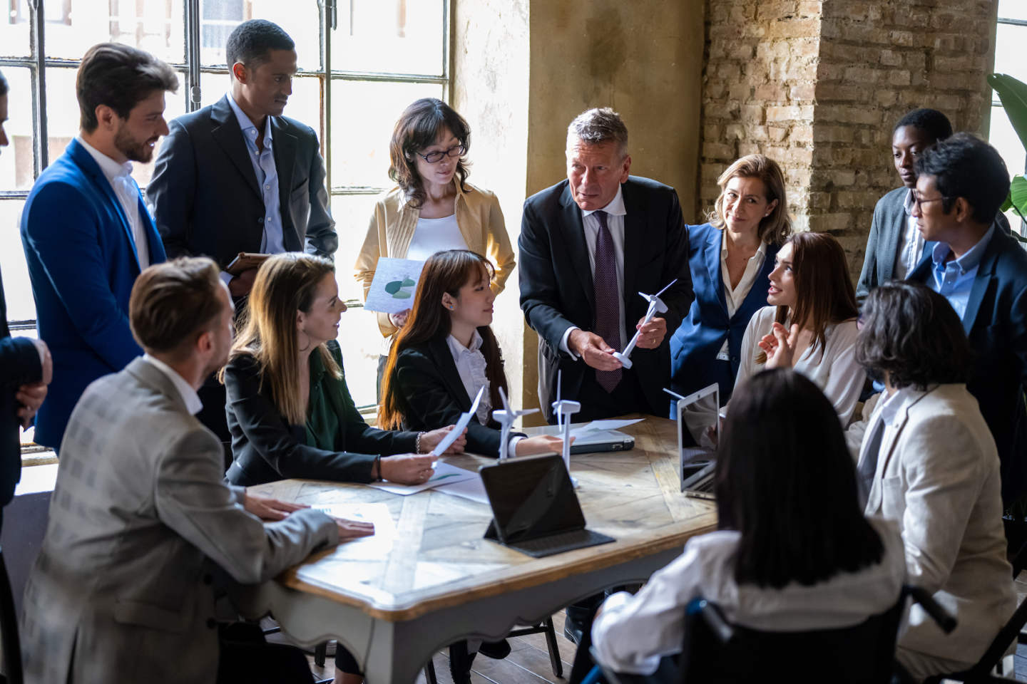 Meeting of entrepreneurs and engineers at the discussion table on energy projects and sustainability challenges from renewable and sustainable sources for the environment, international teamwork briefing