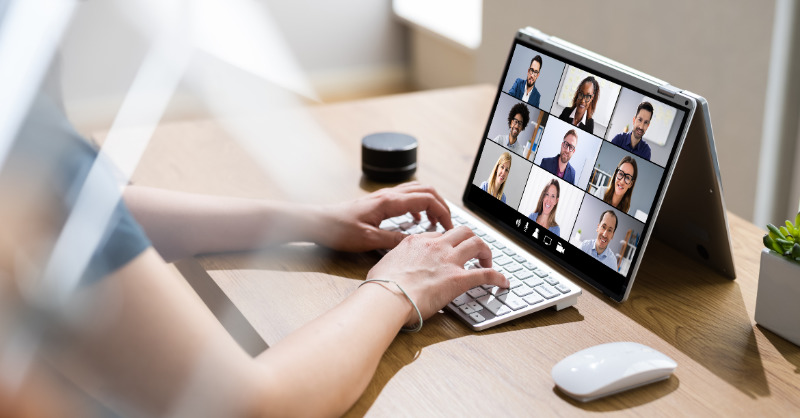 women looking at her tablet which shows a conference call in progress