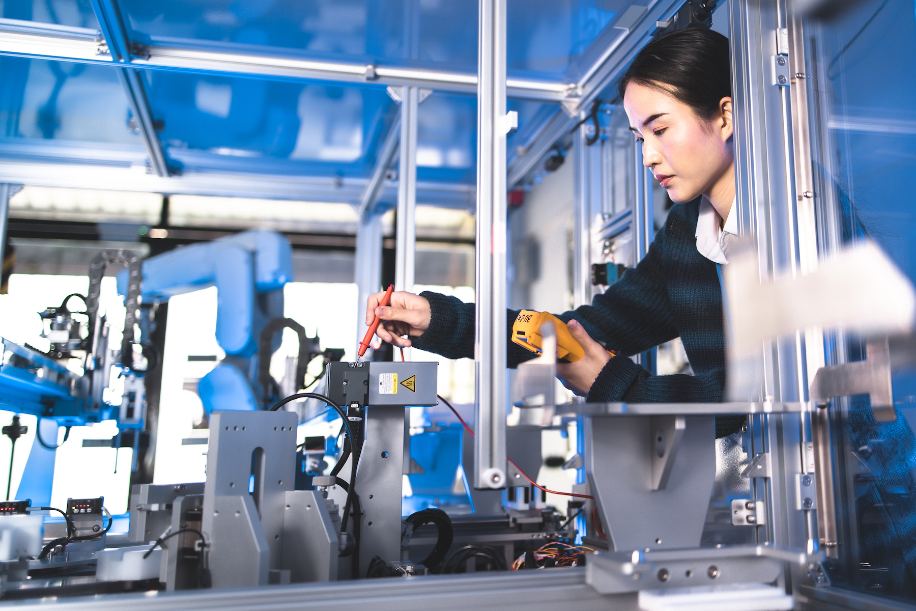 Female engineer working on robotics project.