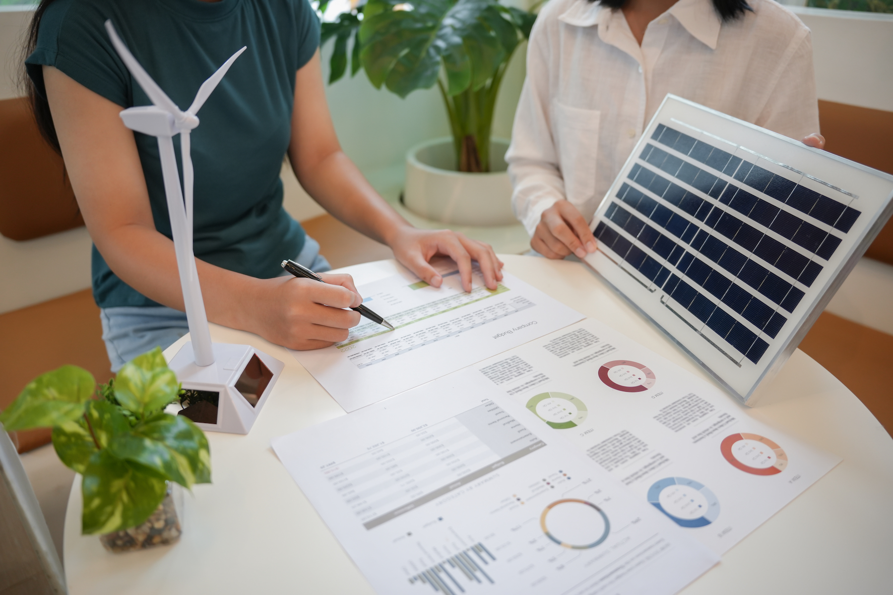 Solar panels green energy Business people working in green eco friendly office business meeting creative ideas for business eco friendly professional teaching corporate people sustainable electricity.