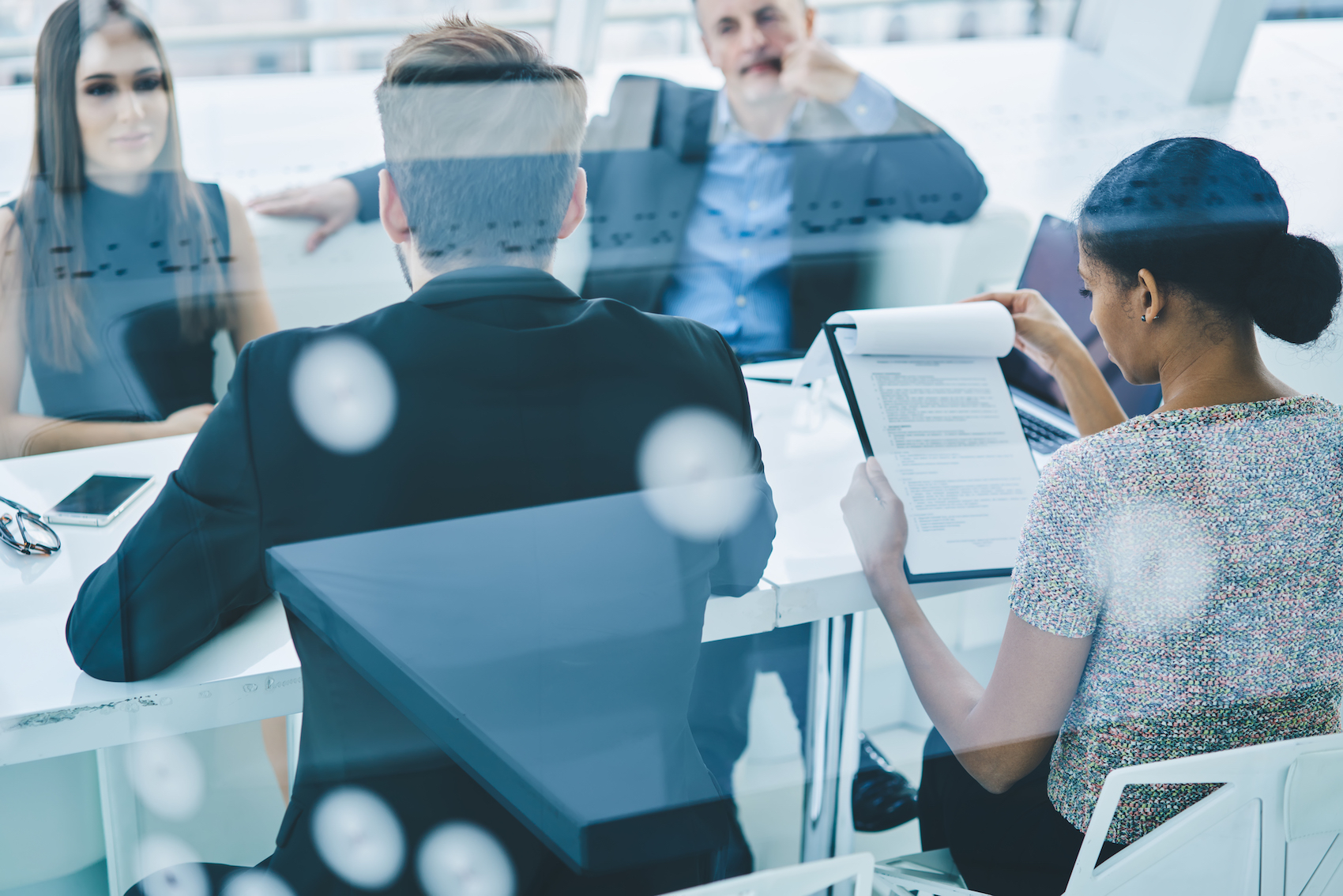 Group of involved partners discussing executive planning during brainstorming meeting at table desktop, professional colleagues discussing marketing and management during work day in office firm