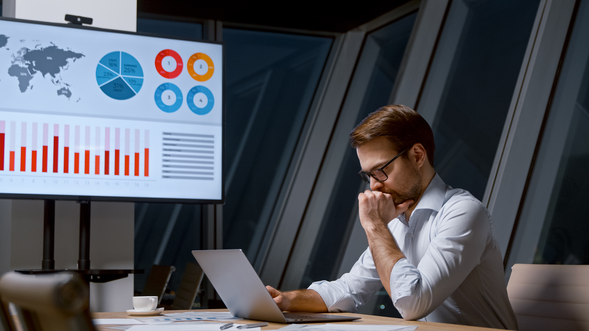 Working corporate leader using computer technology in a meeting room