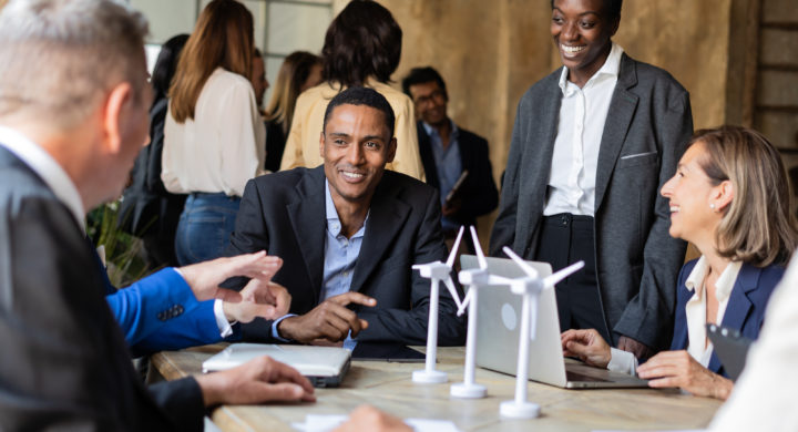 Multiracial group of savvy business professionals gather to discuss the latest developments in renewable energy. Their focused on the importance of their mission to create a more sustainable future.