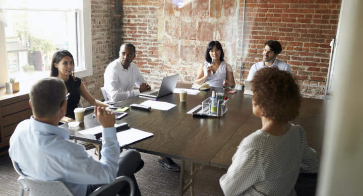Group Of Businesspeople Meeting In Modern Boardroom