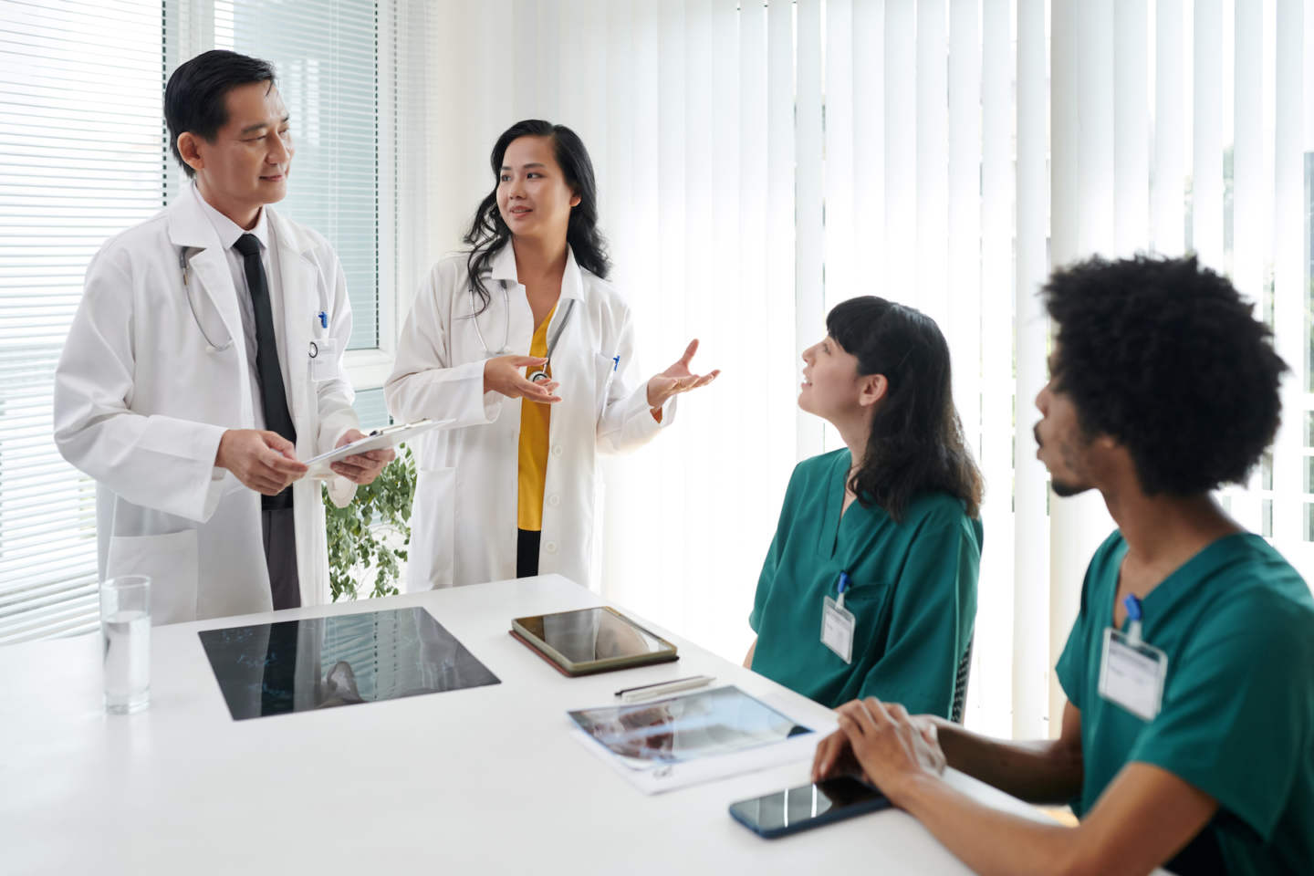 Doctor talking to new nurses, integrating them into organization