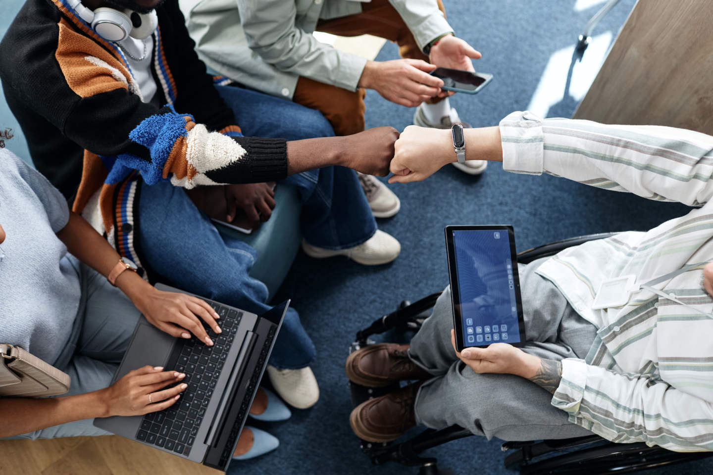 High angle view of teamwork with gadgets during meeting in office