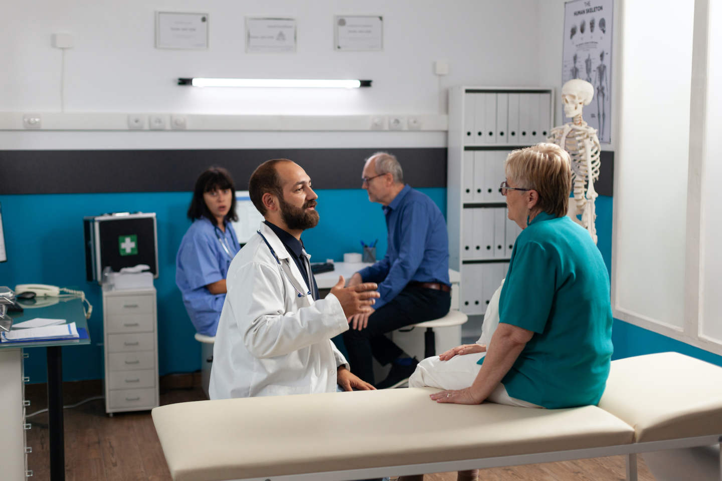 Patient with physical injury talking to doctor about recovery and remedy for healthcare. Medic explaining stretching method to senior woman for chiropractic diagnosis and treatment