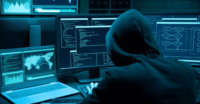 a hacker looking at many screens