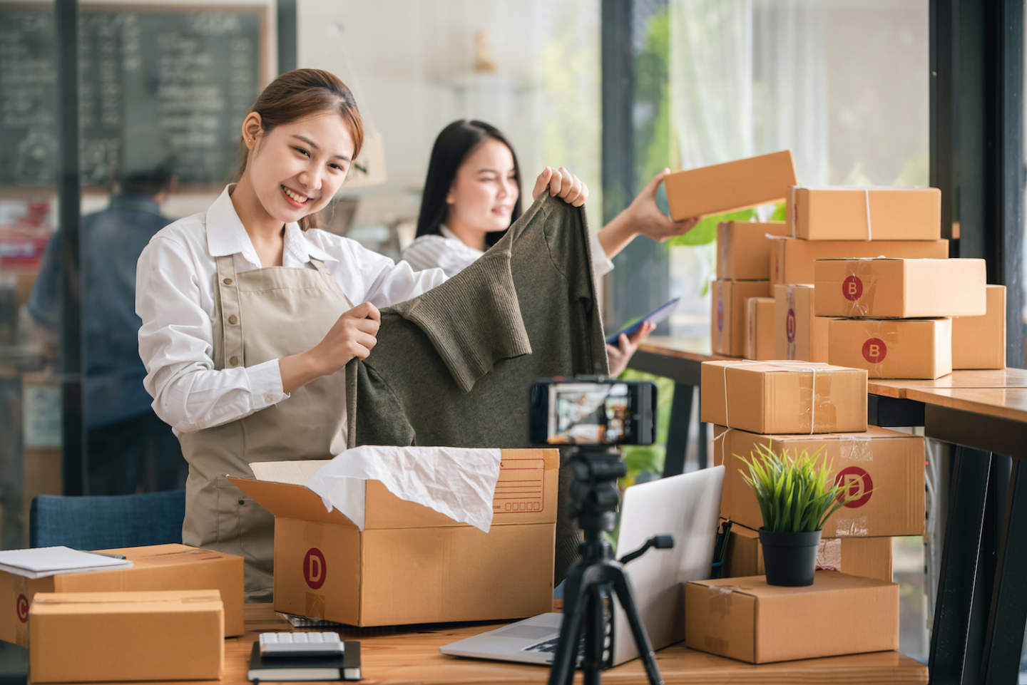 Small start-up business owners live online sales at work, salespeople, check production orders. Pack products, send to customers, sell ecommerce delivery ideas.