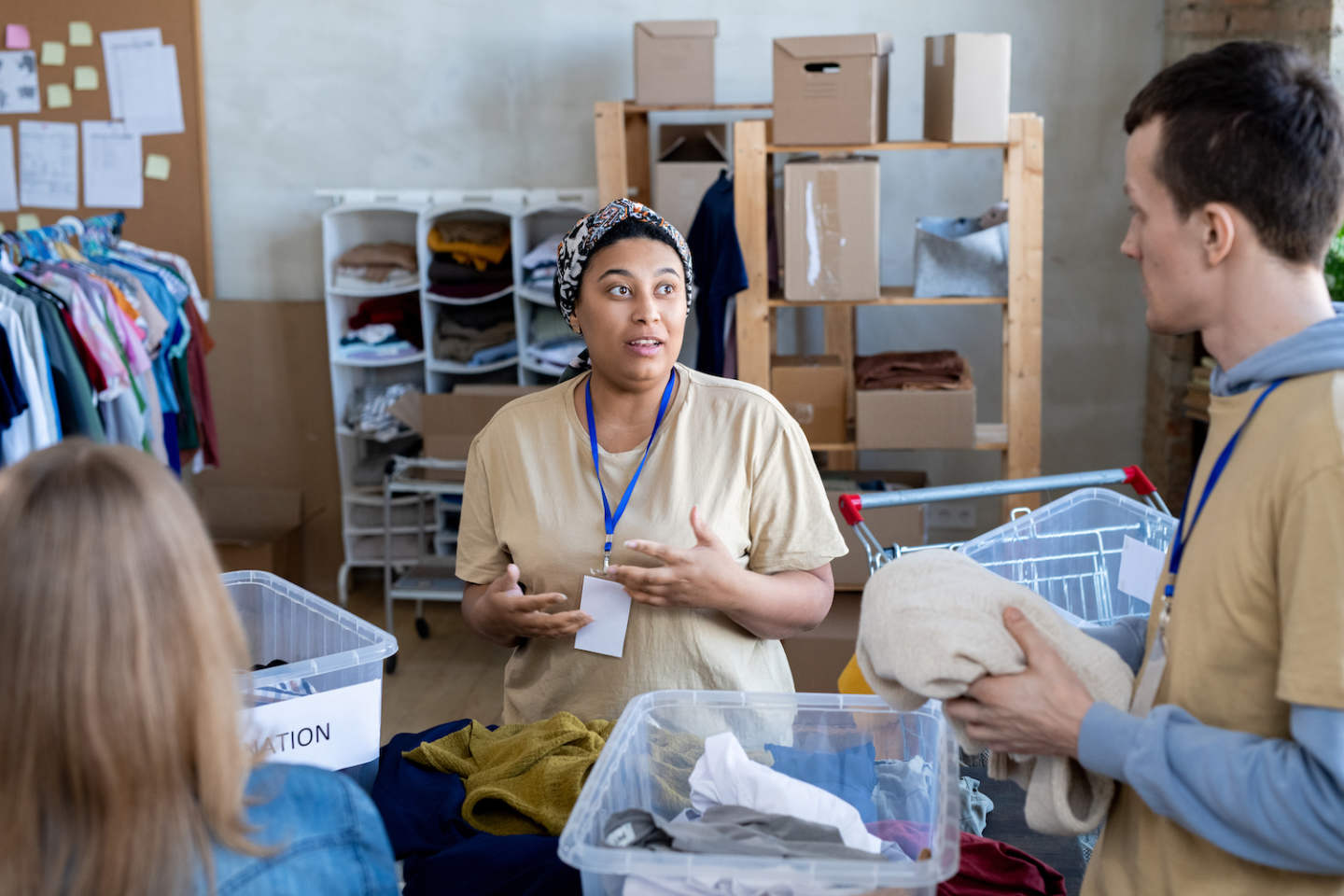 A group of volunteers talking and choosing donation clothes