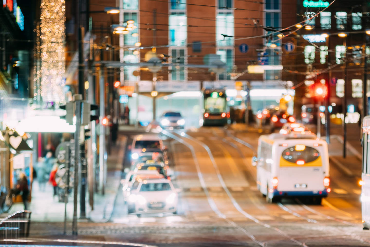 Natural Defocused Blue Bokeh Boke Background Of Night Traffic In Street Of European City. Design Backdrop. Night Illumination