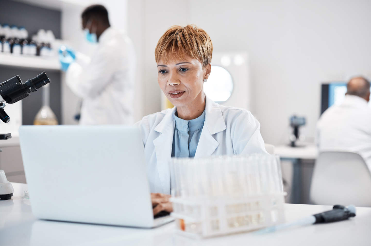 Science, healthcare and scientist with a laptop for research, innovation and pharmaceutical email. .