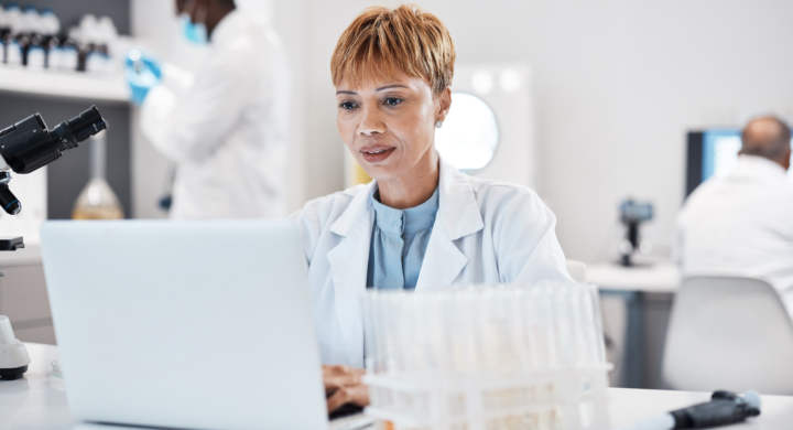 Science, healthcare and scientist with a laptop for research, innovation and pharmaceutical email. .