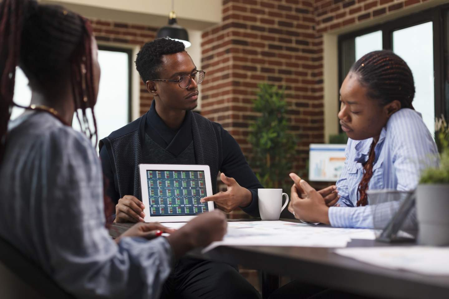 Business development company project manager pointing financial analysis on tablet. Research agency team staff briefed by superior about marketing strategy expenses and possible bankruptcy.