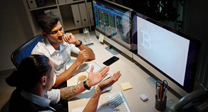 Stock market brokers discussing hype about bitcoin when looking at its ascending price chart
