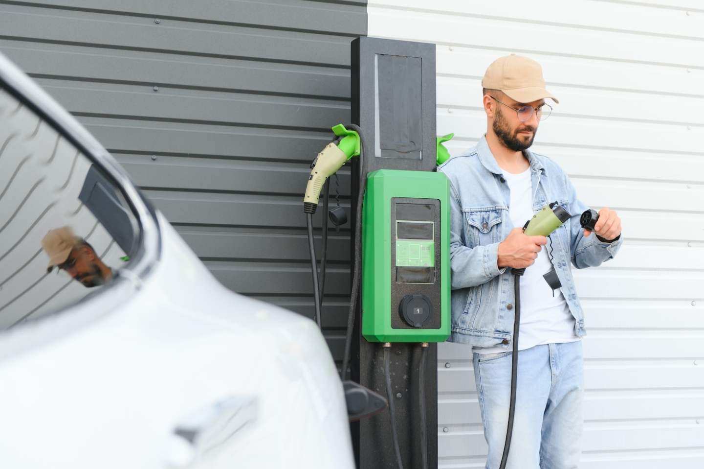 Man standing by his electric car.