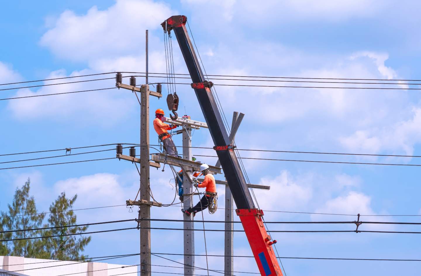3 electricians with crane truck are working together