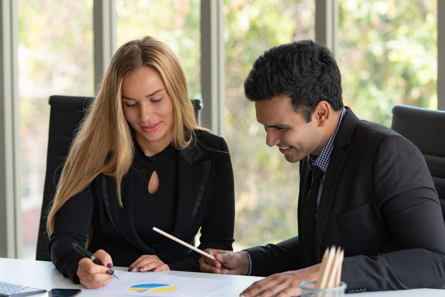 Businessmen, men, women analyze data and consult various issues In the office that has a natural background