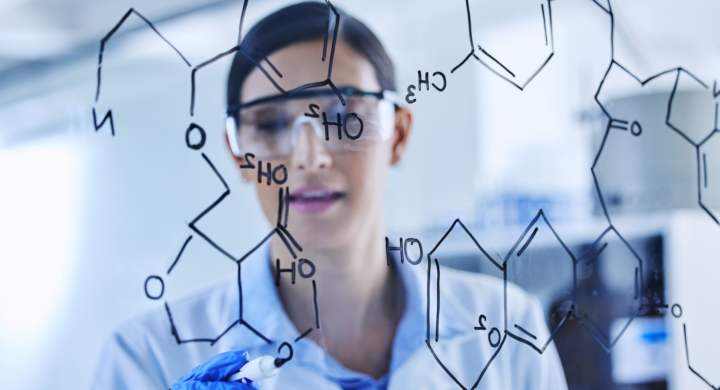 Cropped shot of an attractive young female scientist working on a glass wipe board in her lab.