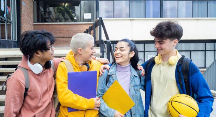 Group of smiling millennial student friends