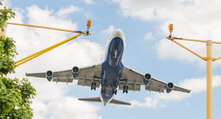 large passenger jet on landing approach to an airport with its undercarriage down