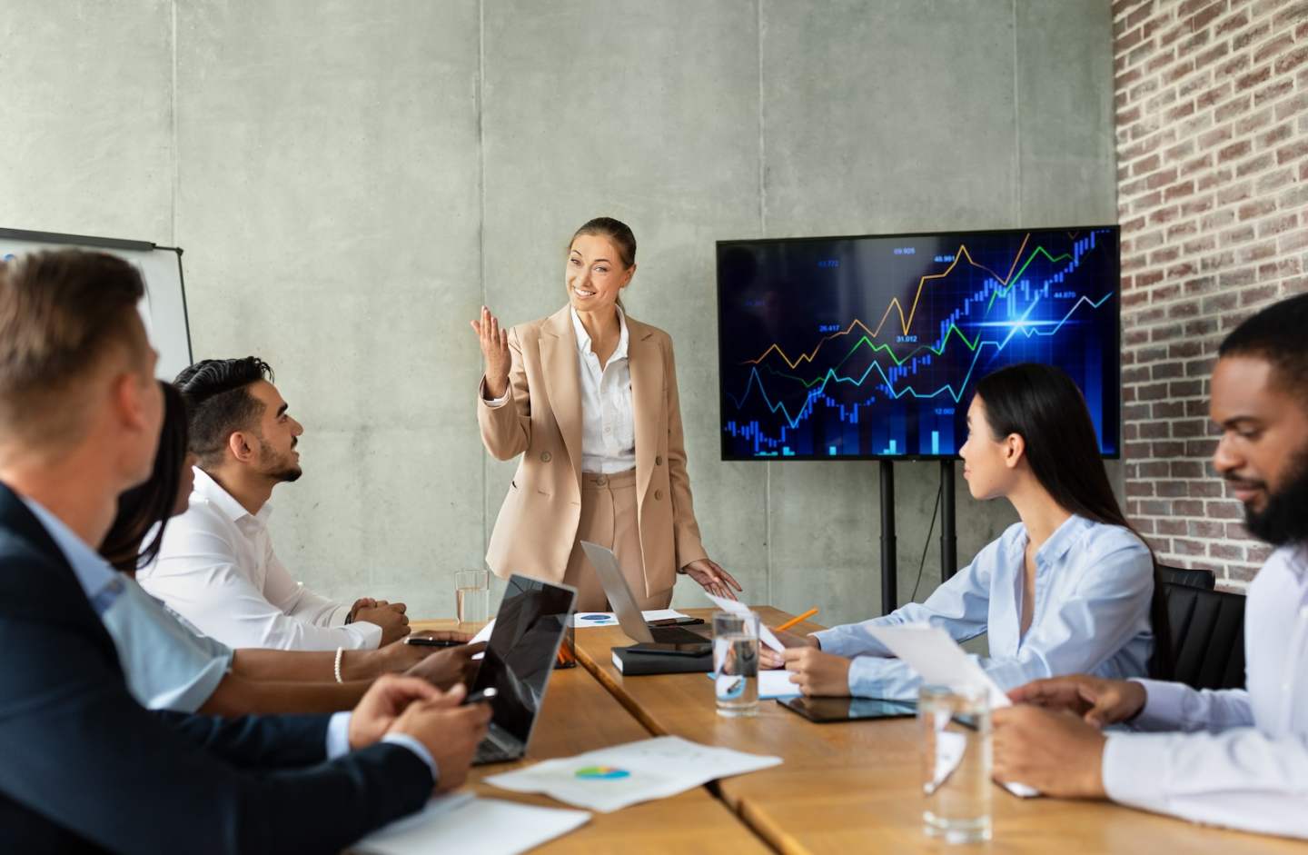 Corporate Meeting. Group Of Multiethnic Coworkers Having Business Conference In Office, Diverse Colleagues Discussing Company Strategy And Brainstorming In Boardroom Together, Discussing Project