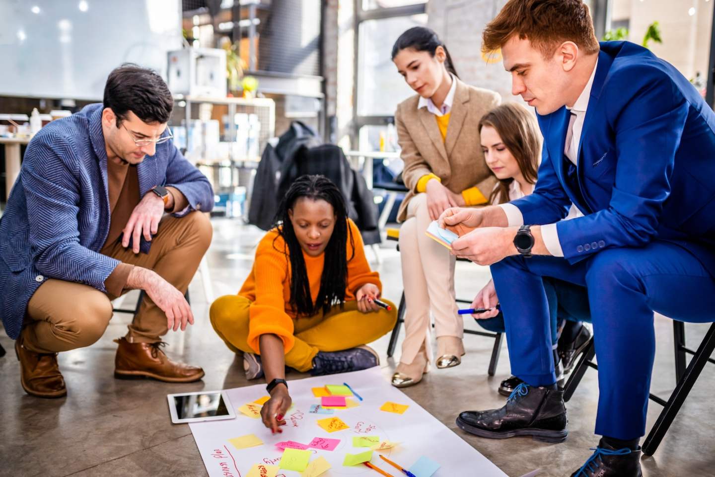 Project managers and employees brainstorming on ideas - Multi-ethnic group of workers having business meeting in a start-up office
