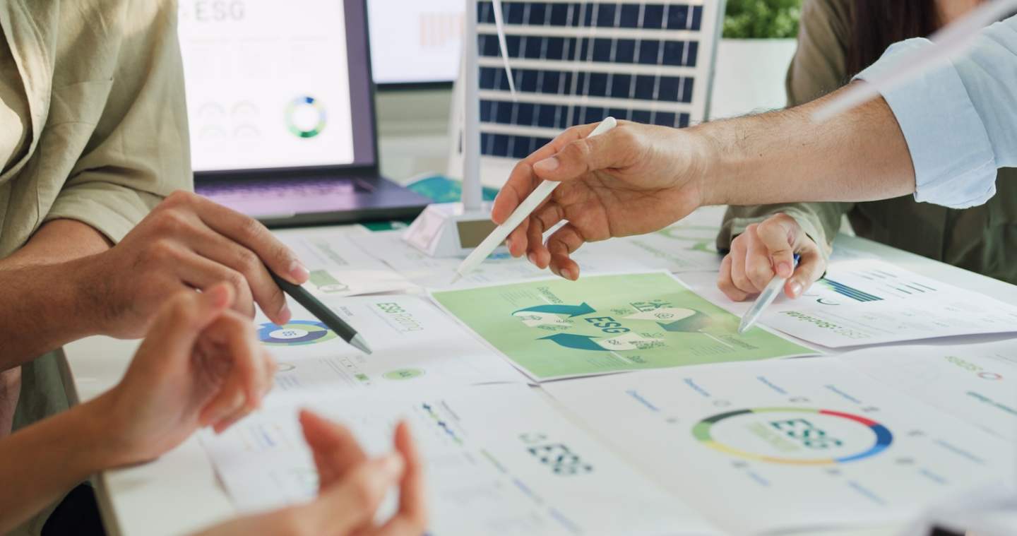 Closeup group Asia businesspeople talk ESG strategies risk management workshop, SDGs report, global warming, green finance investment eco friendly and net zero waste in boardroom training building.