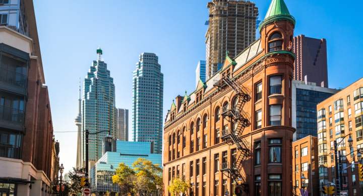 Gooderham or Flatiron Building in downtown Toronto with CN Tower on background - Toronto, Ontario, Canada