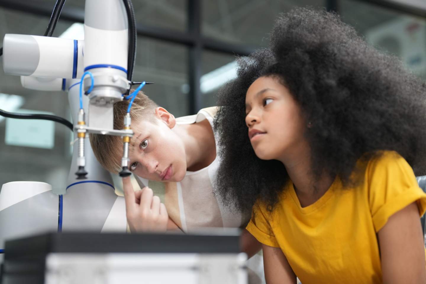 Children learning AI technology Robot with artificial intelligence system on its about the artificial intelligence during science lesson.