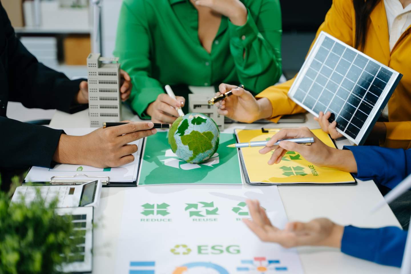 business team people planning and discussing on recycle reduce reuse policy symbol in office meeting room. Green business company and Solar Energy Environment city Concept.