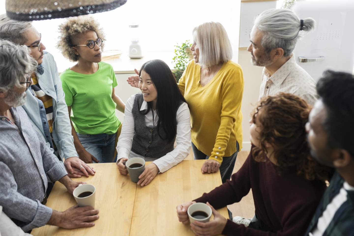 group of multiethnic people meeting in kitchen working