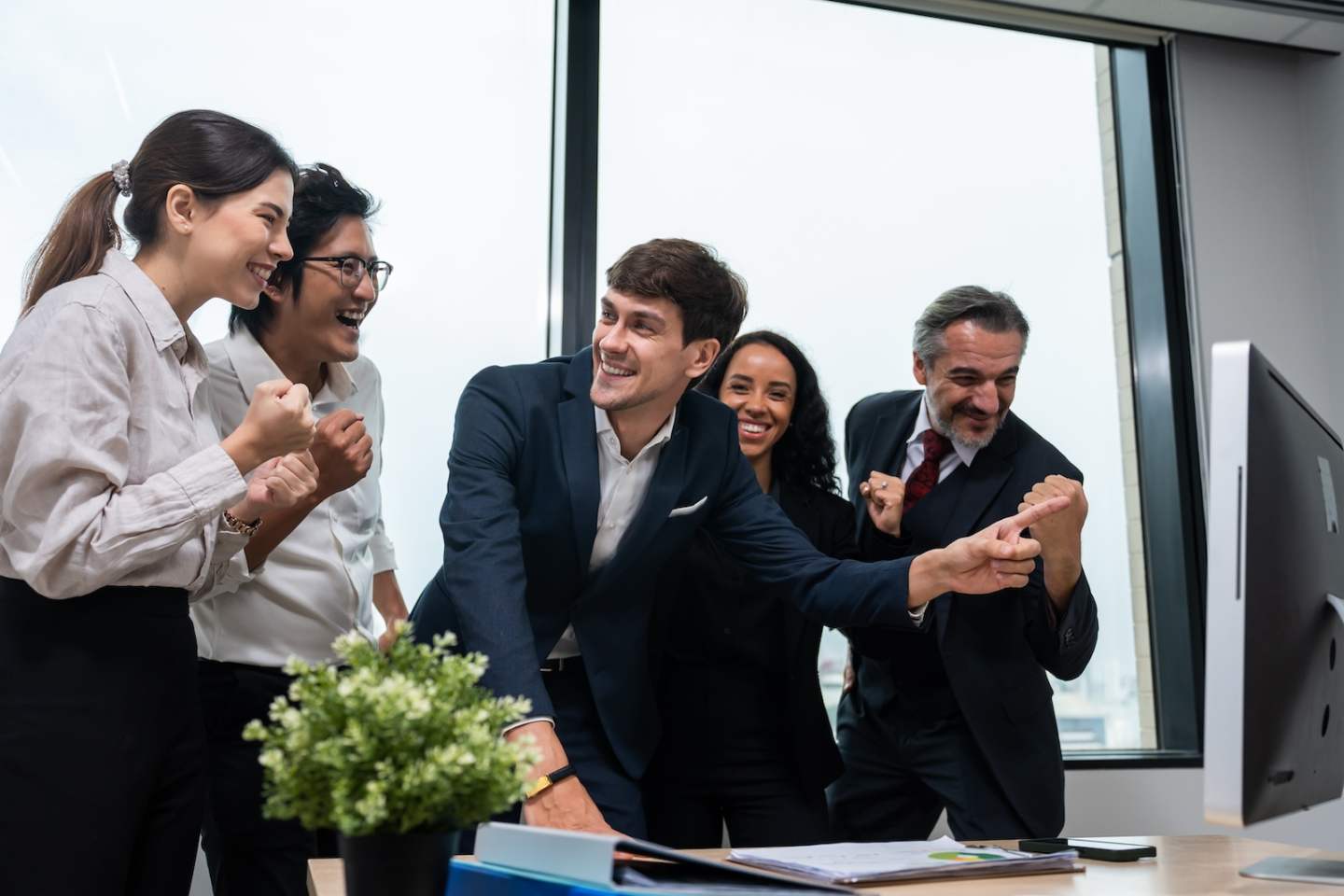 Group of multi-Ethnic businessman and businesswoman clapping together. Attractive employee worker feel happy, motivate each other and work as unity teamwork to discuss project in corporate workplace.