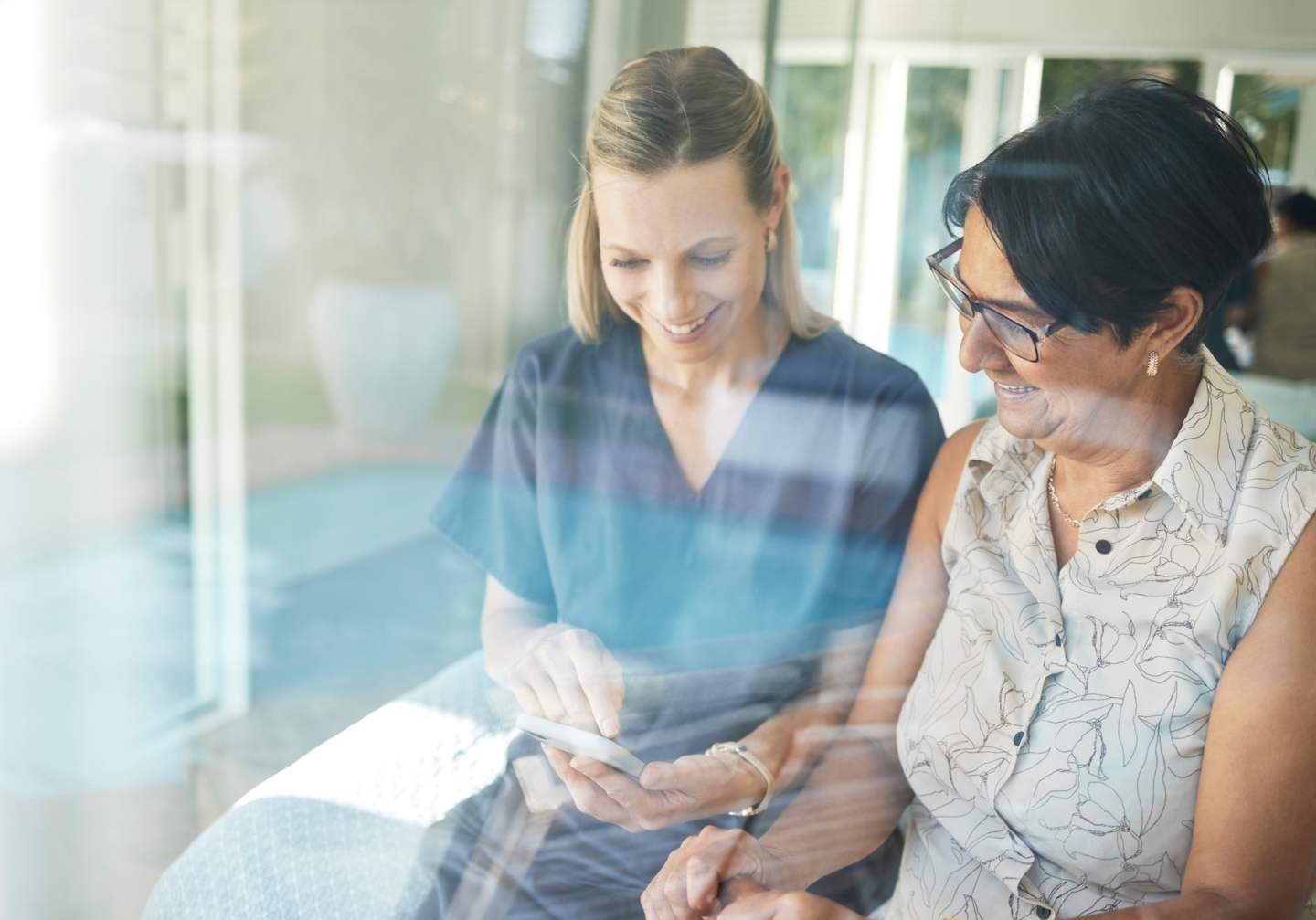 Happy woman, nurse and phone with senior in elderly care for support, consultation or healthcare di.