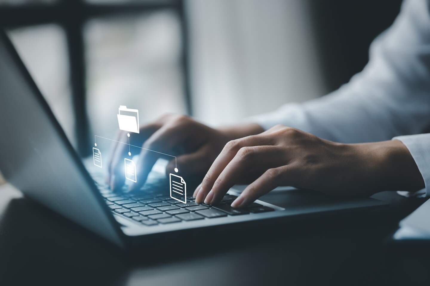 business man typing on a keyboard with holograms of digital document files, data files on computers stored as cloud databases can be viewed online and prevented data loss from the device.